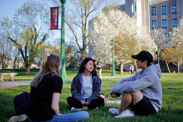 Students hanging out on the School of Education lawn
