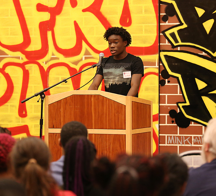 Student Prince Jackson shares his writing at the African-American Read-In