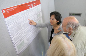 Wenjing Zheng, associate instructor in the special education program at the IU School of Education, discusses a poster outlining a study conducted with Otting Chair Erna Alant. 