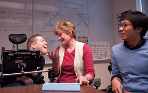 Professor Erna Alant (center) sits with an IU graduate student and a person who uses augmentative and alternative communication.