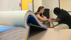 A student teacher from the IU School of Education at IUPUI works with a student in IPS' George Washington Community High School.