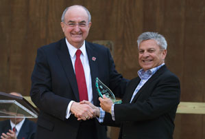 IU President Michael McRobbie presents Dean Gerardo Gonzalez with the IU Latino Faculty and Staff Council's Outstanding Achievement Award