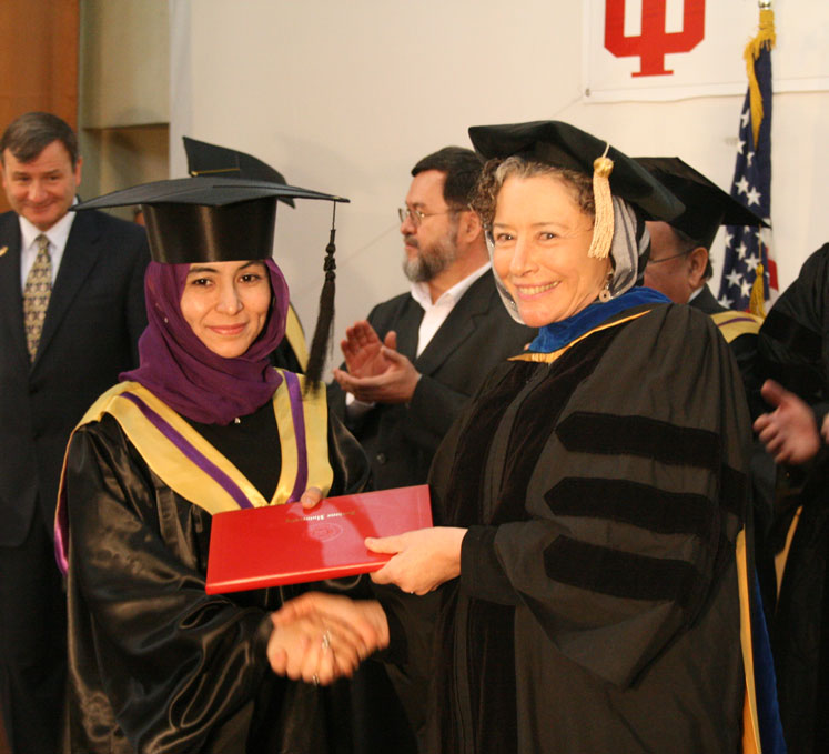 Mitzi Lewison (on right), professor of language, culture, and literacy education, congratulating an Afghan participant in the higher education program during graduation ceremonies in 2011.