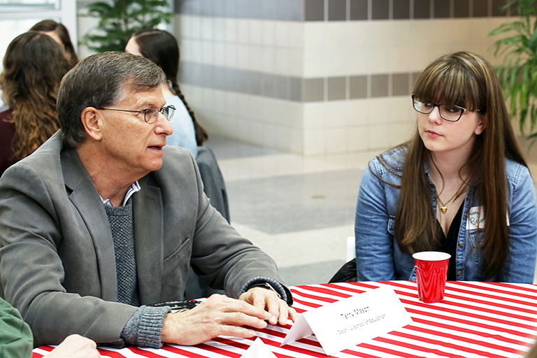 Terry Mason talks with students