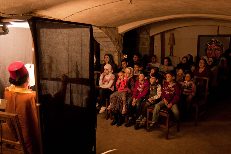 Children enjoy a traditional art performance. Damascus, Syria. 