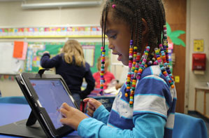 A Center Grove student using an iPad.