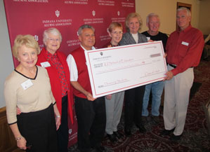 Class of 1963 committee members present their fundraising total to IU School of Education Dean, Gerardo Gonzalez, and Alumni Board President, Doug Williams (left to right:  Sandra Moberly, Erdine Simic, Gerardo Gonzalez, Shirley Gut, Martha Street, Ronald Hancock, and Doug Williams).