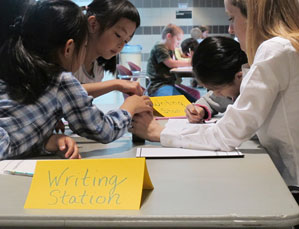 Elementary students working at a writing station during the kickoff event for the Academic Resource Clinic for K-8 Students at the Wright Education building on April 18.